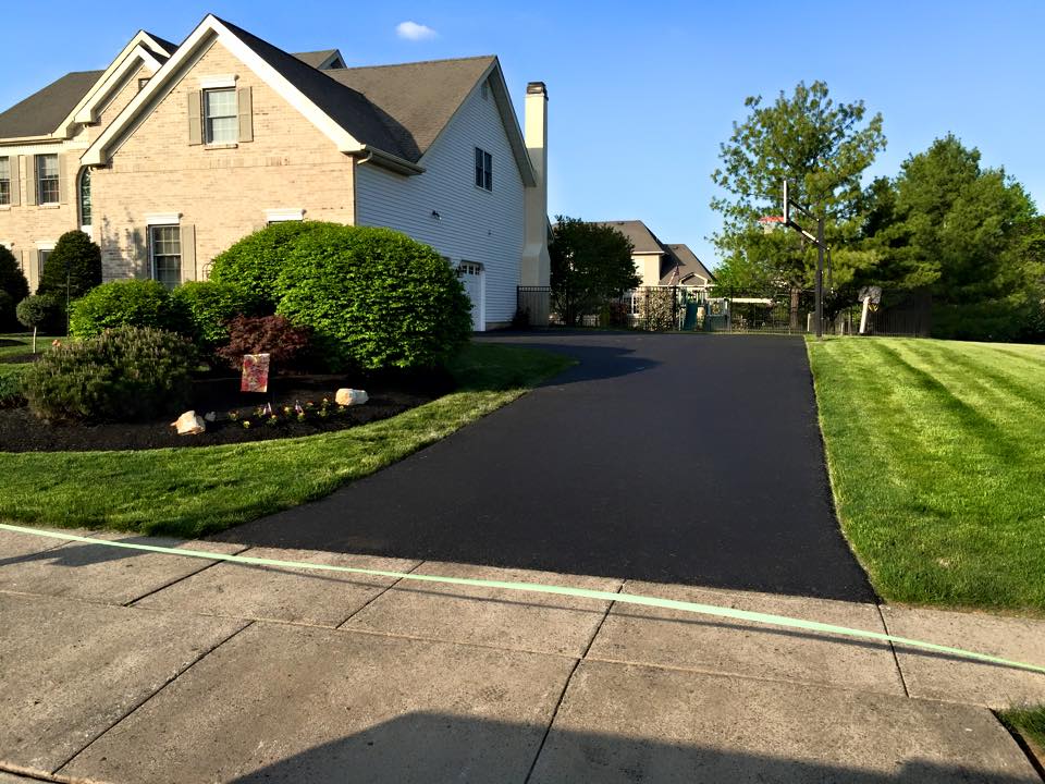 The finished result of a home driveway paving completed by Platinum Paving and Sealcoating