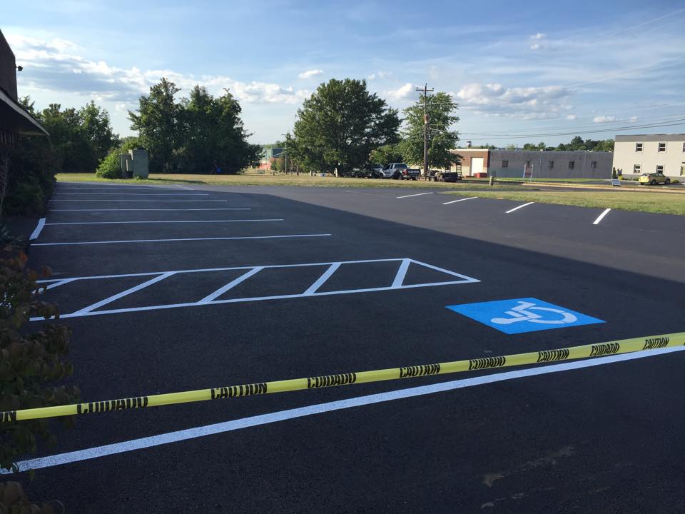 Freshly painted parking lot with line striping and handicap parking space image